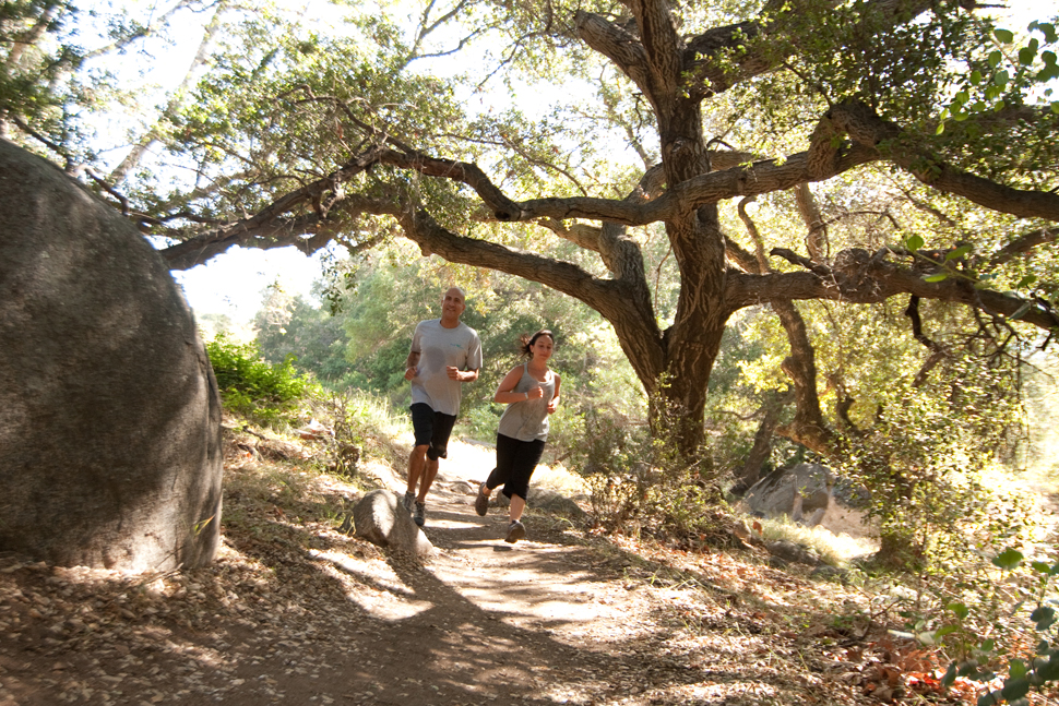 A couple jogs on a nature path at Rancho La Puerta Spa