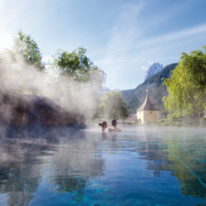 A couple enjoying thermal springs at ADLER Spa Resort DOLOMITI