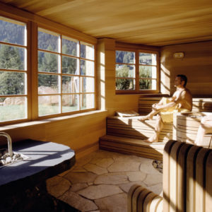 A guest enjoying a sauna with views at ADLER Spa Resort DOLOMITI