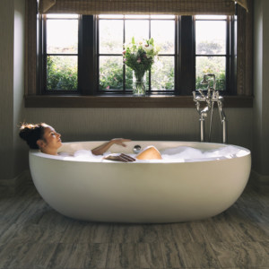 A guest relaxes in a deep tub at Salamander Spa