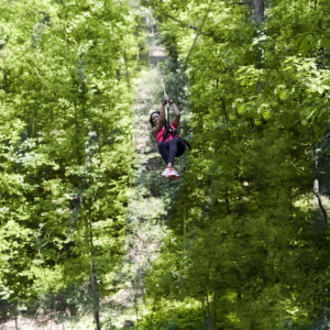 A guest enjoys a zip-line tour at Salamander Spa