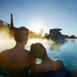 A couple relaxes in a thermal pool at ADLER Spa Resort THERMAE