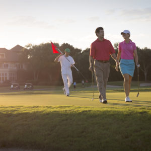 A couple plays golf at The Lodge, The Spa at Sea Island